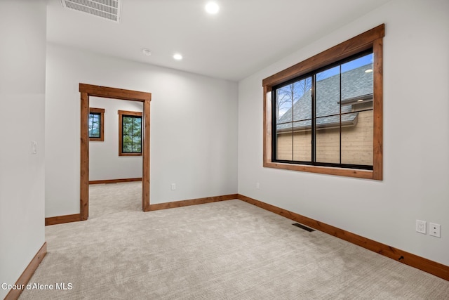 carpeted spare room with recessed lighting, visible vents, and baseboards