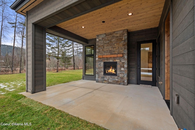 view of patio with an outdoor stone fireplace