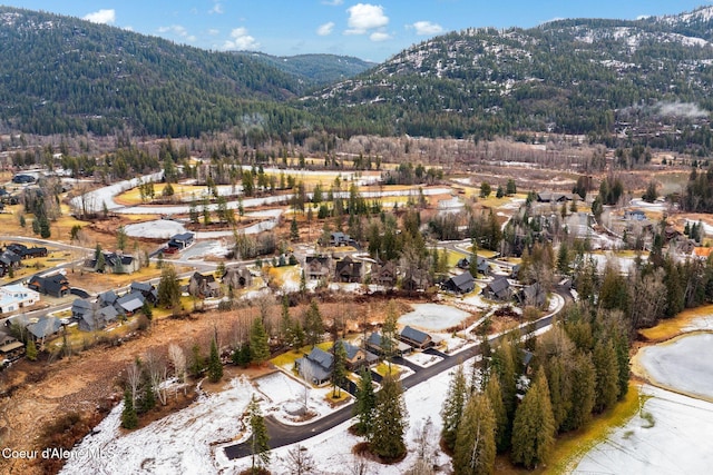 drone / aerial view with a forest view, a residential view, and a mountain view