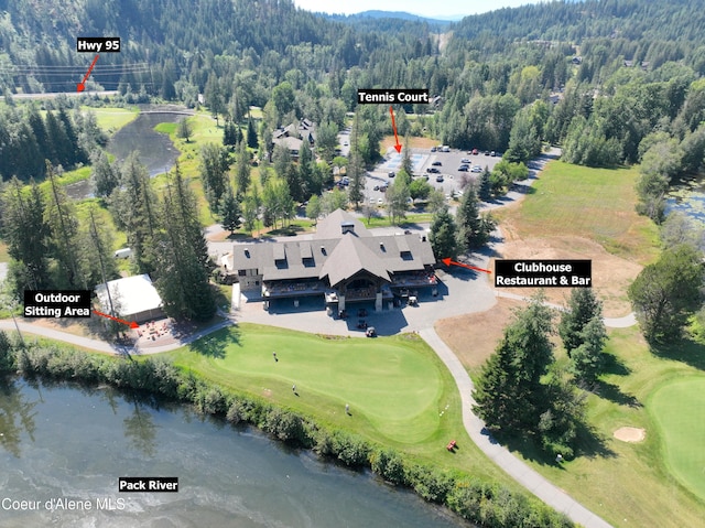 bird's eye view featuring view of golf course, a water view, and a wooded view