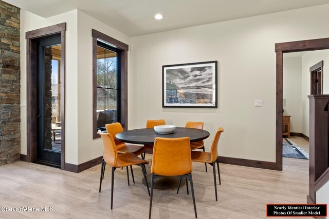 dining space with baseboards, recessed lighting, and light wood-style floors