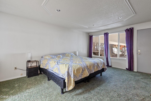 carpeted bedroom with a textured ceiling and baseboards