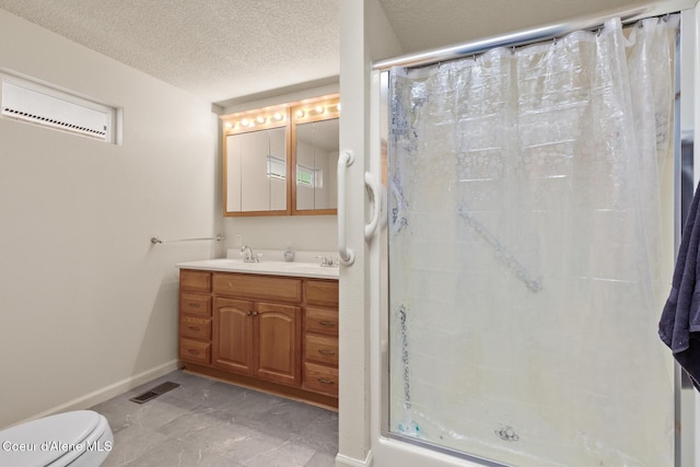 bathroom featuring double vanity, visible vents, toilet, a textured ceiling, and a shower stall