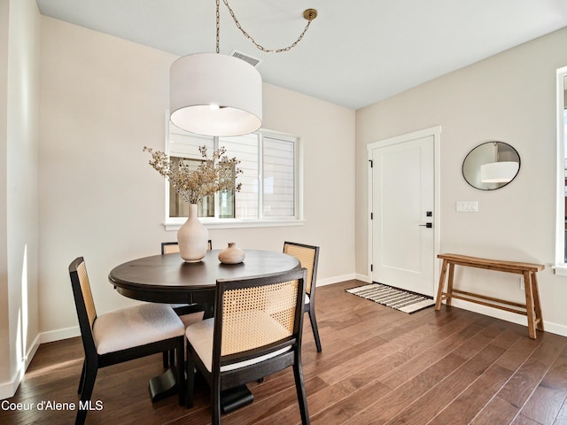 dining area featuring visible vents, baseboards, and dark wood-style flooring