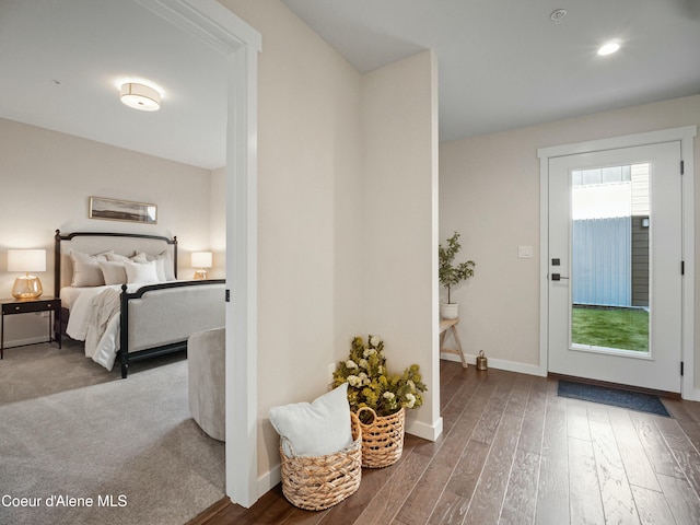 interior space with baseboards and wood finished floors