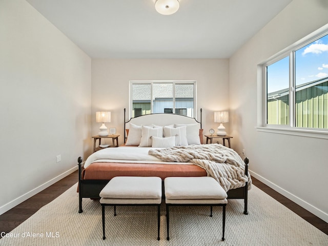 bedroom featuring baseboards and wood finished floors