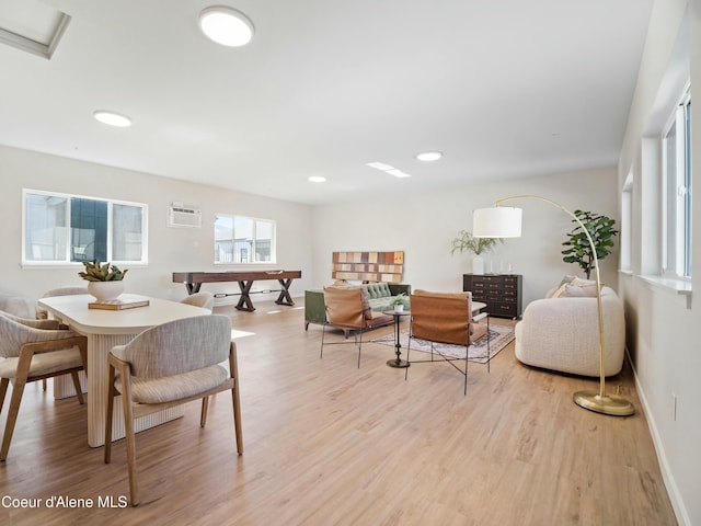 dining room featuring recessed lighting, a wall mounted AC, baseboards, and wood finished floors