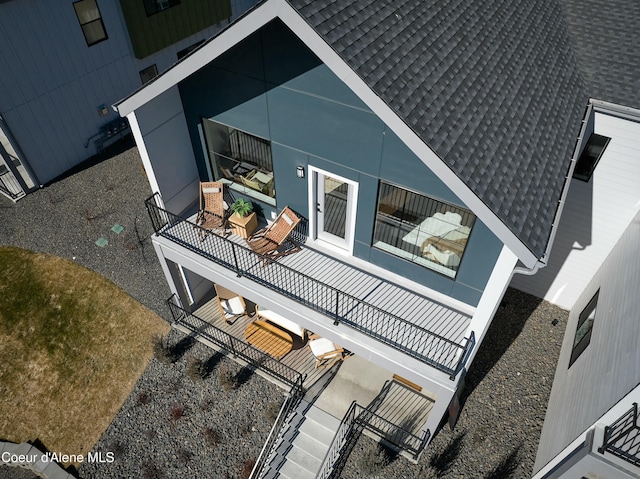 view of side of home featuring a shingled roof