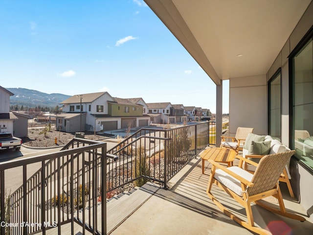 balcony featuring a mountain view and a residential view