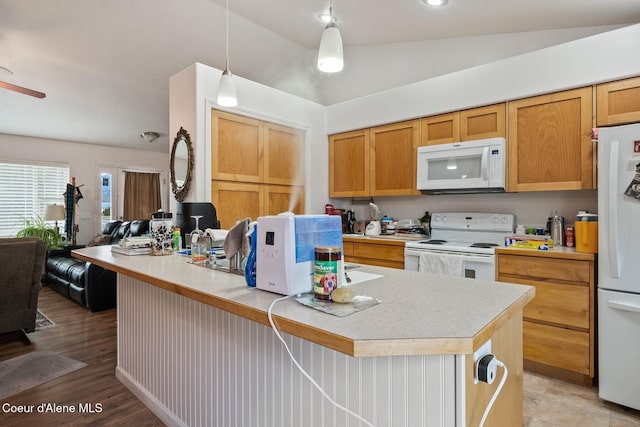 kitchen with white appliances, pendant lighting, light countertops, and a kitchen island with sink