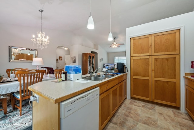 kitchen with a sink, arched walkways, open floor plan, and white dishwasher