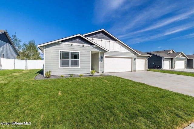 ranch-style home with an attached garage, board and batten siding, fence, driveway, and a front lawn