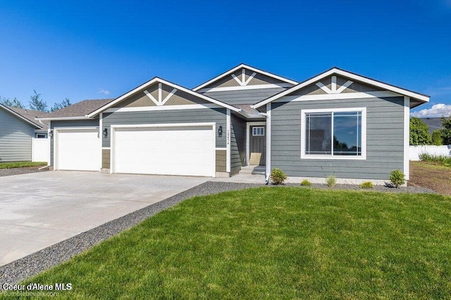 view of front of house with a garage, driveway, and a front lawn