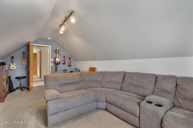 living room featuring lofted ceiling, light carpet, a textured ceiling, and track lighting