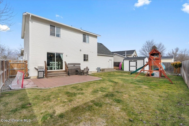 back of house with an outbuilding, a patio, a fenced backyard, a lawn, and a shed