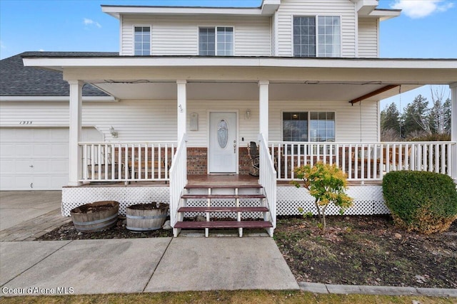 view of front of house with a porch and a garage