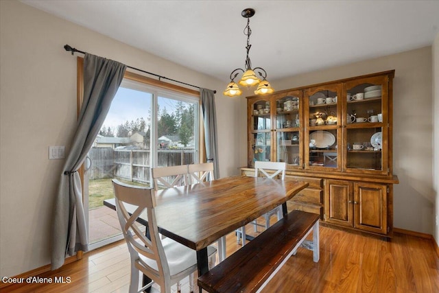 dining area featuring baseboards and light wood-style floors