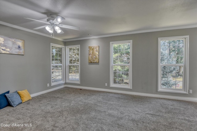 spare room with crown molding, plenty of natural light, carpet floors, and ceiling fan