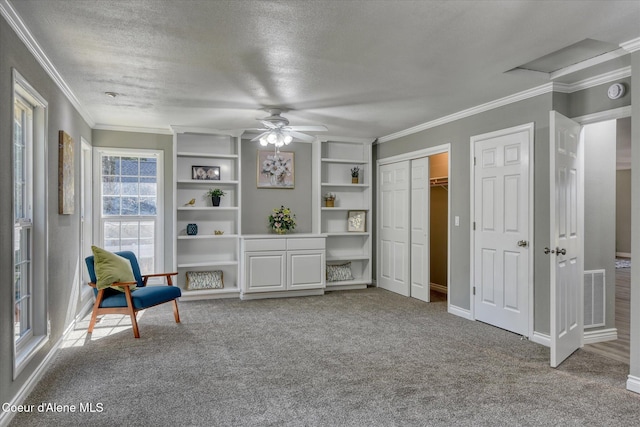 unfurnished room featuring ornamental molding, carpet flooring, visible vents, and a textured ceiling