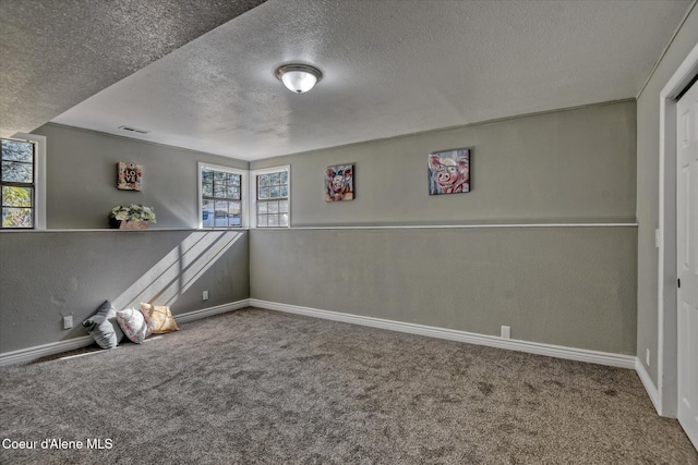 unfurnished room with visible vents, plenty of natural light, and carpet