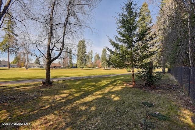 view of community with fence and a lawn