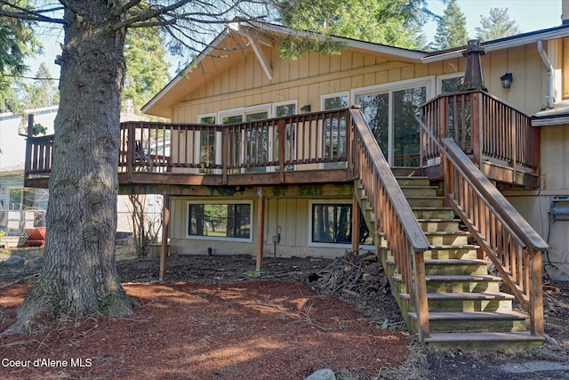 back of house featuring a wooden deck and stairs