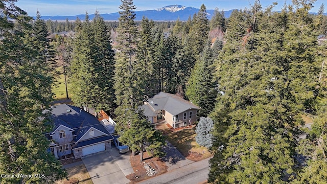 aerial view featuring a mountain view and a wooded view