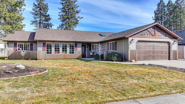 ranch-style home featuring a front yard, an attached garage, and driveway