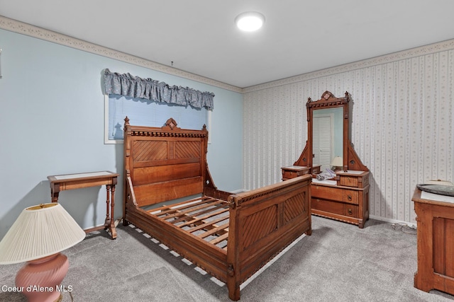 carpeted bedroom with baseboards and wallpapered walls