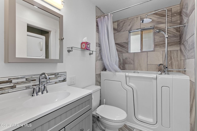 full bathroom featuring tasteful backsplash, shower / tub combo, vanity, and toilet