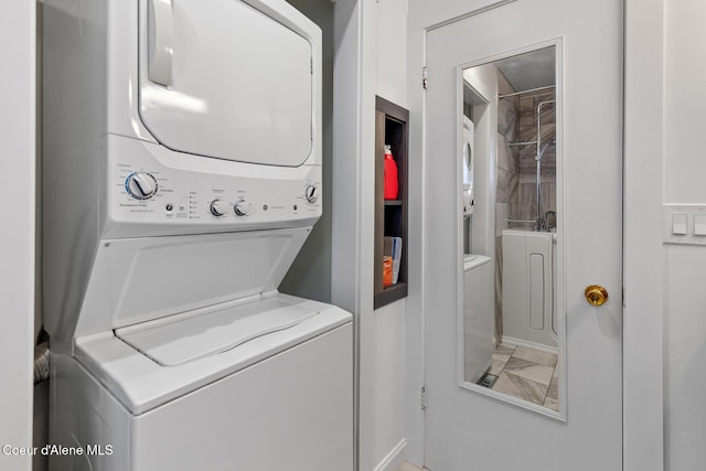 laundry room with stacked washer and clothes dryer and laundry area