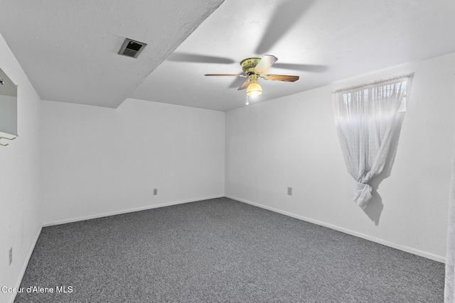 spare room with carpet flooring, ceiling fan, and baseboards