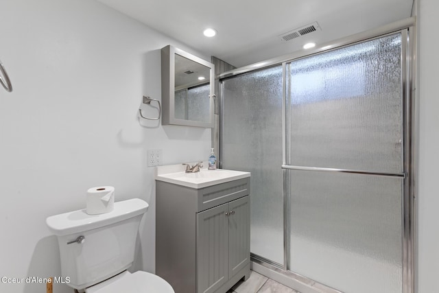 bathroom featuring a stall shower, visible vents, vanity, and toilet