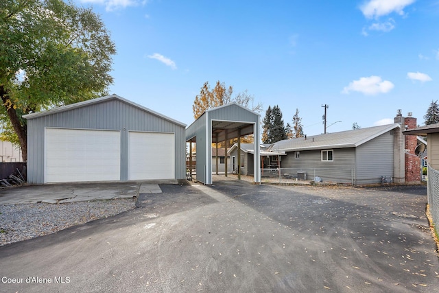 view of front of property with an outdoor structure and a detached garage