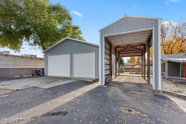 garage featuring a garage and fence