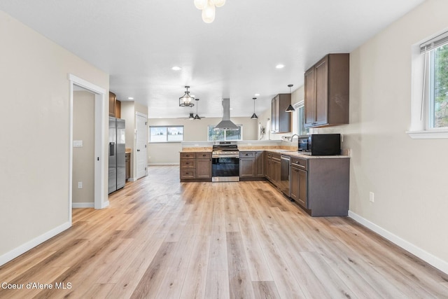 kitchen featuring stainless steel appliances, baseboards, light wood-style flooring, and island range hood