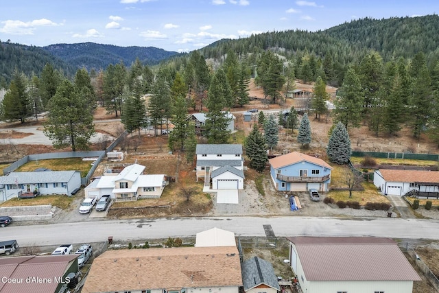 birds eye view of property with a residential view, a mountain view, and a view of trees