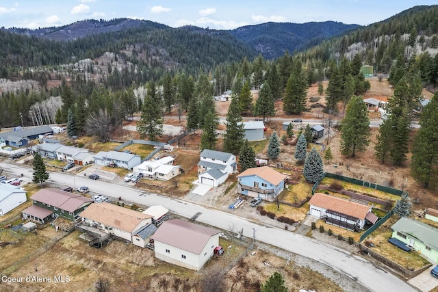 birds eye view of property with a mountain view and a wooded view