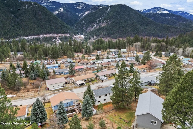 aerial view with a forest view, a residential view, and a mountain view