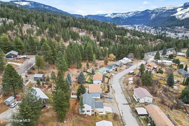 drone / aerial view with a mountain view and a wooded view