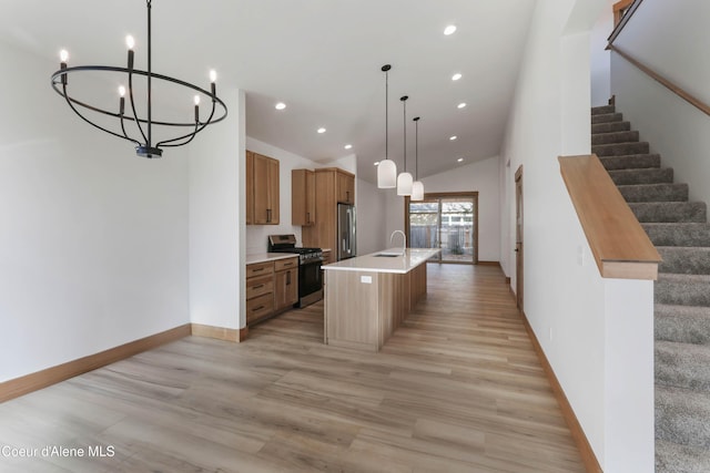 kitchen featuring baseboards, stainless steel appliances, light countertops, light wood-style floors, and recessed lighting