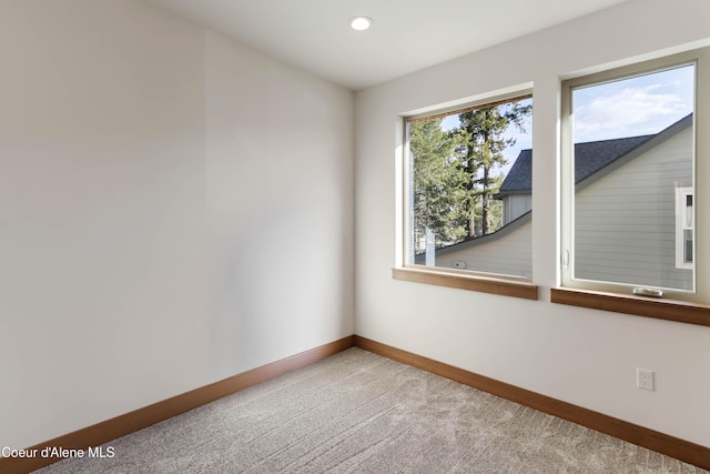 spare room with recessed lighting, carpet flooring, and baseboards