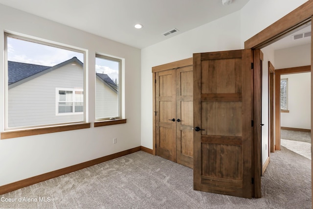 unfurnished bedroom with carpet floors, recessed lighting, visible vents, and baseboards