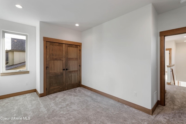 unfurnished bedroom featuring carpet floors, recessed lighting, visible vents, and baseboards