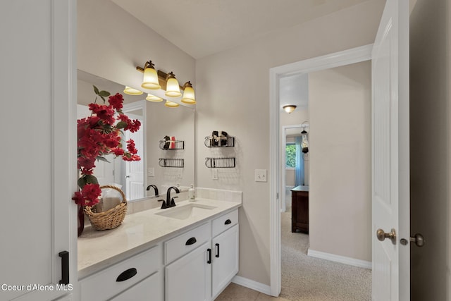 bathroom with vanity and baseboards