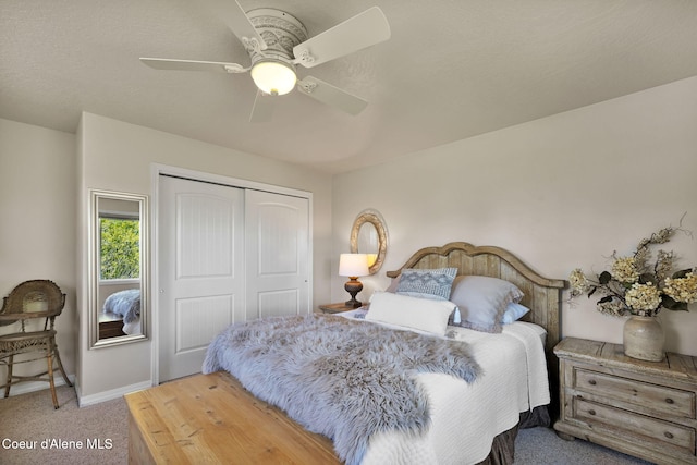 carpeted bedroom featuring a closet, a ceiling fan, and baseboards