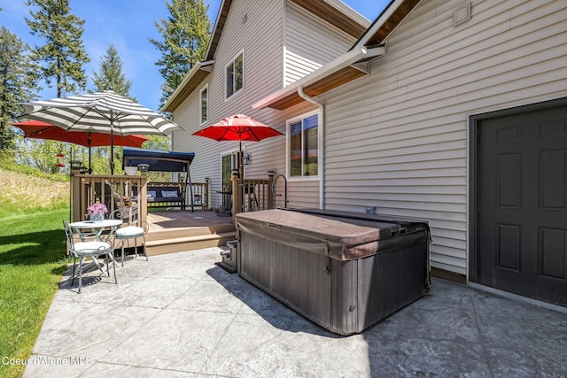 view of patio with a hot tub and a wooden deck