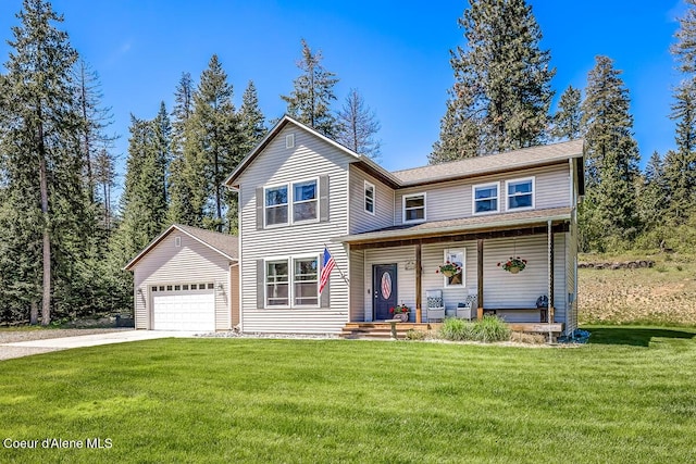 traditional home with a garage, a front yard, and driveway