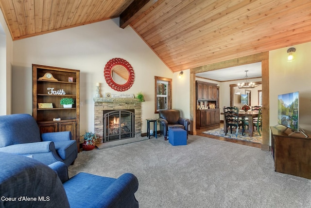 living room with carpet, wood ceiling, a stone fireplace, a chandelier, and beamed ceiling