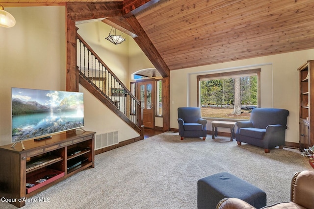 carpeted living area with baseboards, visible vents, wooden ceiling, stairs, and high vaulted ceiling